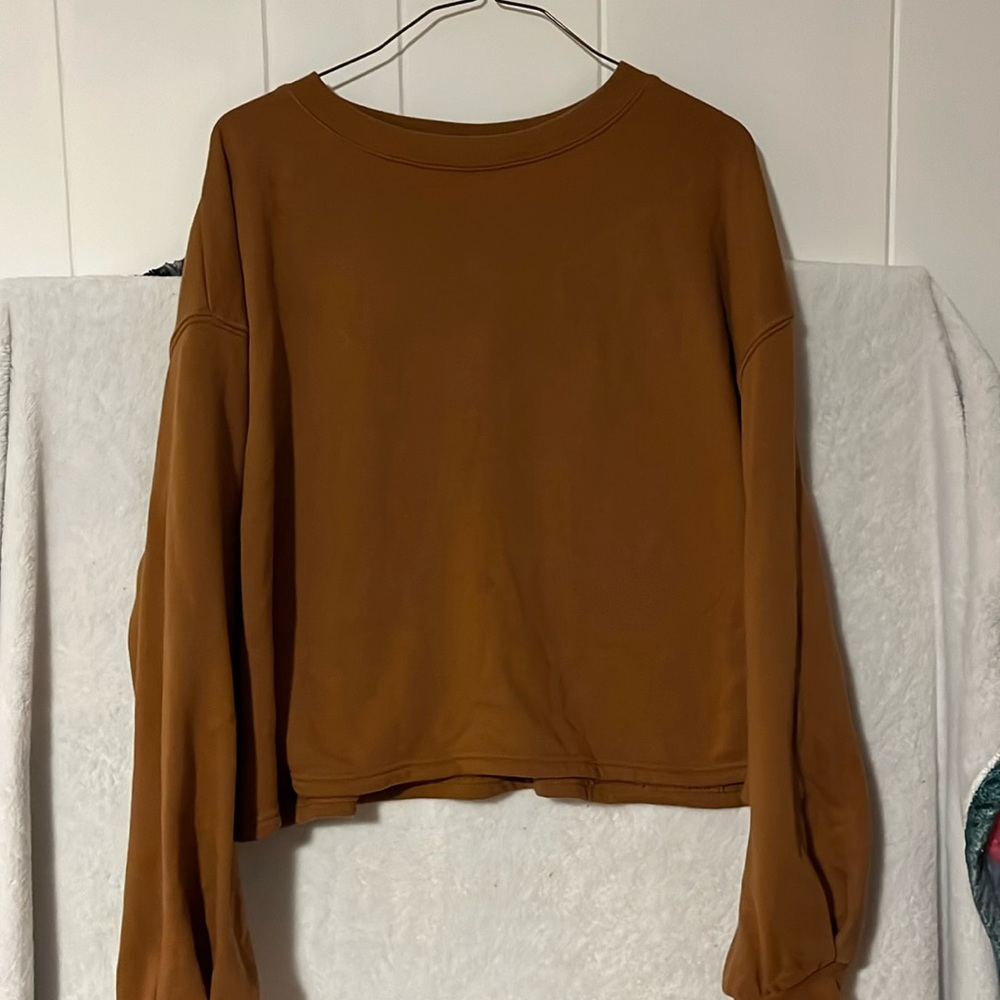 Wool lined sweater. Slightly cropped, stops at waist. Tanish brown color.